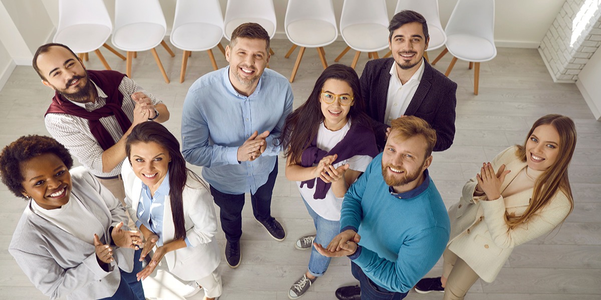 smiling-office-employees-looking-up-at-camera